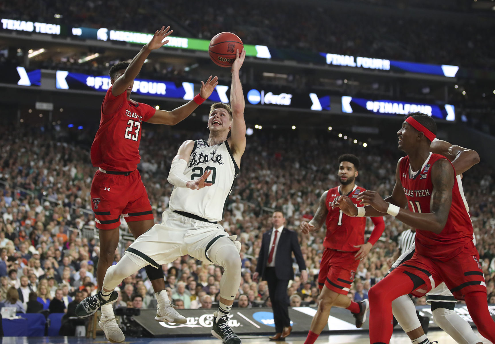 Michigan State's Matt McQuaid (20) shoots under Texas Tech's Jarrett Culver (23) during the first half in a semifinal of the NCAA Tournament Final Four on Saturday, April 6, 2019, at U.S. Bank Stadium in Minneapolis.